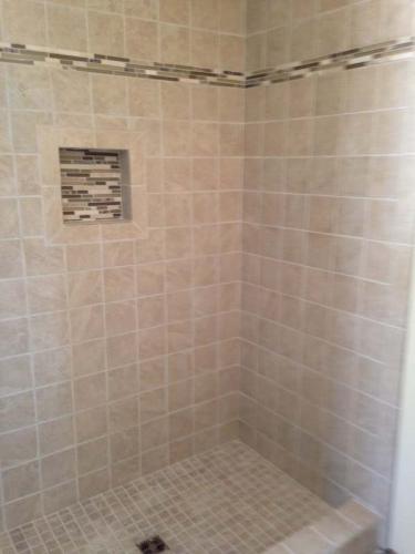 Fresh tile in this custom shower add a sense of luxury to this bathroom, done by Braendel in Erie, PA.