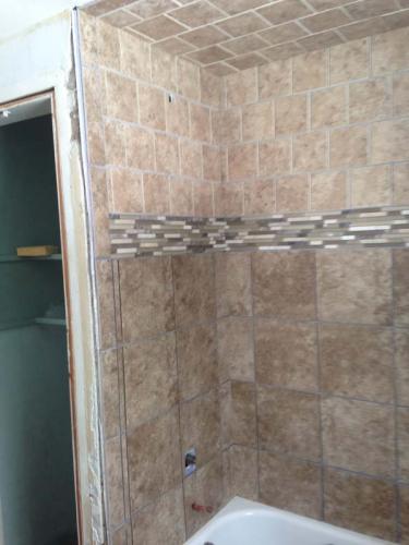 Shower is done in this custom bathroom. Next up: a fresh coat of paint and new floors!