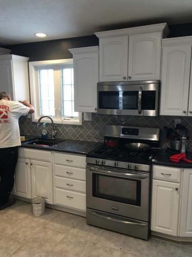 Braendel Services team members putting on the final touches of this new kitchen.
