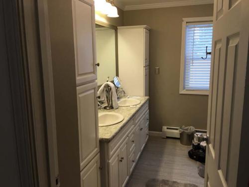 This new custom bathroom with double vanity sinks is going to be a couple's sanctuary.