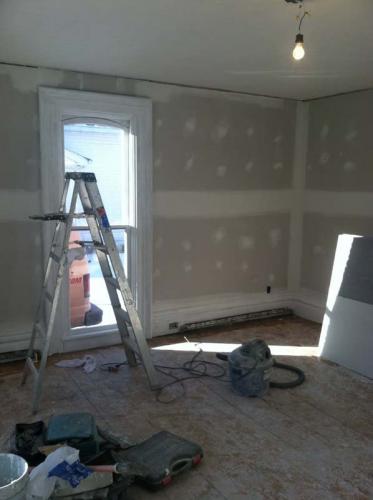 The walls of this room have been hung and prepped for fixtures and painting