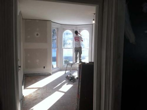 Once the drywall has been installed, finishing touches are being put on by a Braendel team member before the paint and wallpaper. 