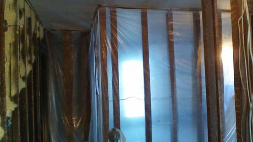 Tarping the framework of a wall during an interior renovation. 