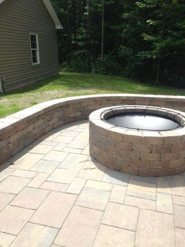 A firepit, rimmed by masonry, is a great addition to any backyard. 