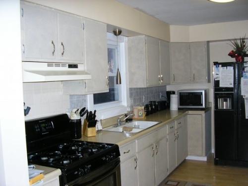 The pairing of light cabinets and dark appliances creates a stark contrast in this new kitchen.