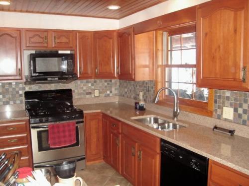 Brand new cabinets, fresh floors, and tile backsplashes all make this remodeled kitchen fabulous.