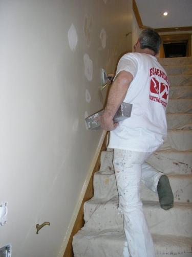A Braendel crew member patches holes in the wall before getting started on an interior job. Paying attention to details like this ensures that the job is done perfectly!