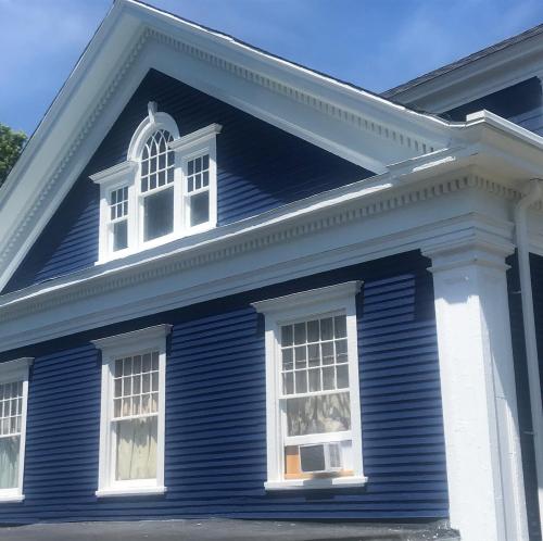 This deep blue siding and fresh trim make this house memorable. 