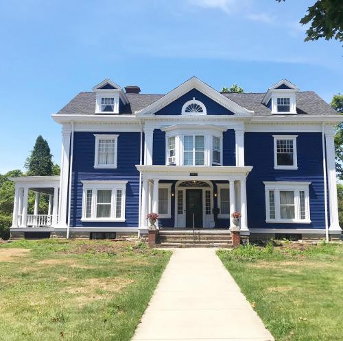 A gorgeous home stands back form the street, looking fresh with new siding installed by Braendel Services.