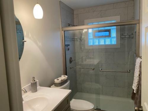 Replacing a surround with a tile shower and glass doors is a great way to modernize any bathroom