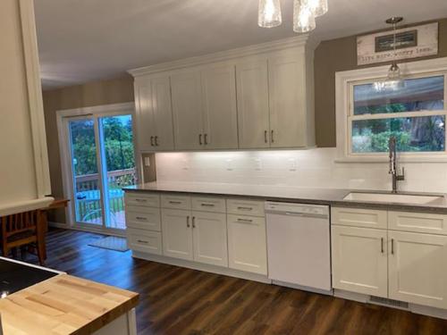 Subway tile backsplash and white shaker style cabinets produce a look that is clean and timeless